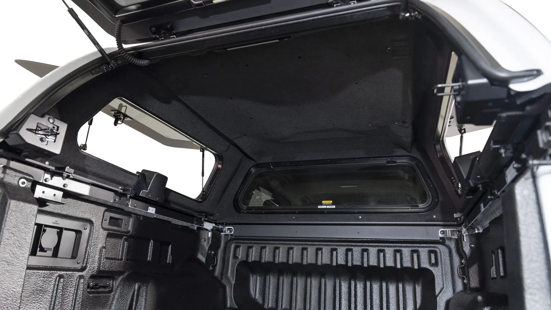 Interior of an EGR GEN3 Canopy showing carpet-lined ceiling, LED lighting, and pop-out side windows with gas struts