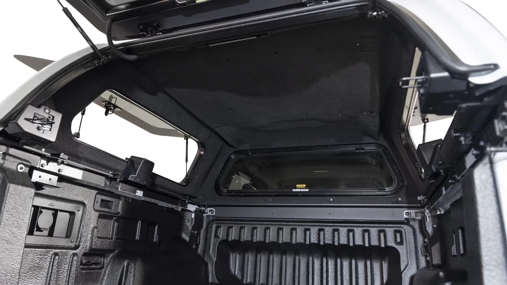 Interior of an EGR GEN3 Canopy showing carpet-lined ceiling, LED lighting, and pop-out side windows with gas struts