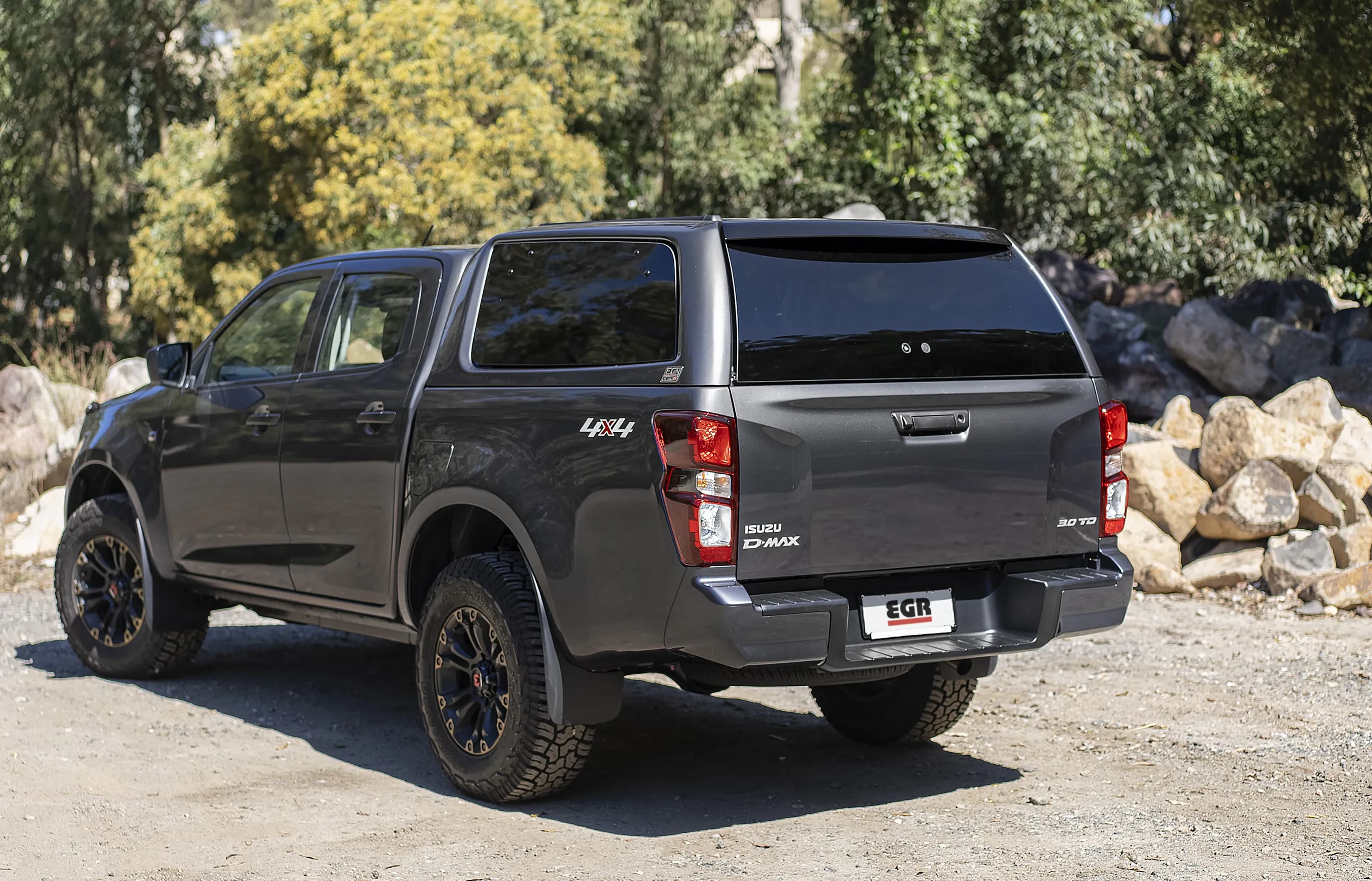 Dark grey Isuzu D-Max with a colour-matched EGR GEN3 Canopy parked on an Australian bush track
