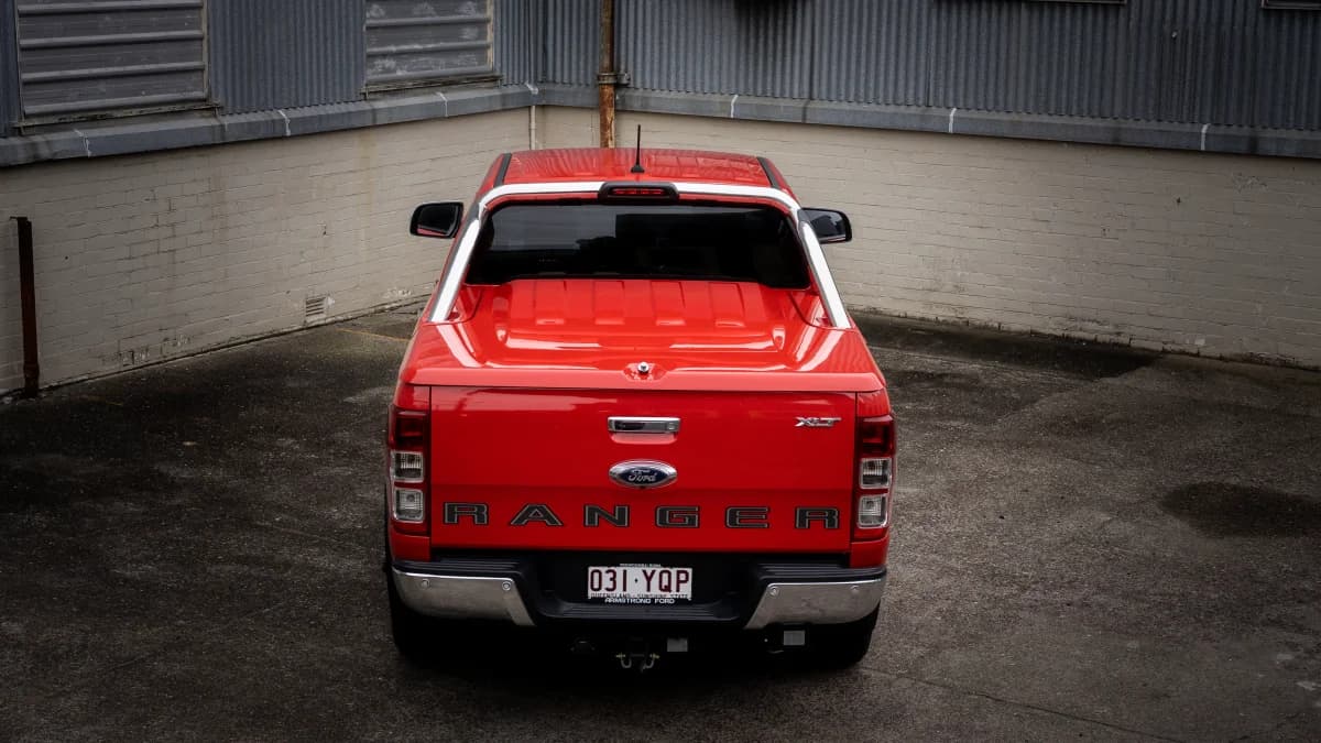 Rear view of a red Ford Ranger with an EGR hard lid in a warehouse