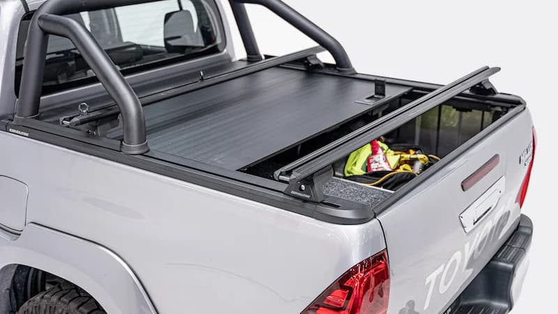 EGR RollTrac open with crossbars and gear loaded in the ute tub