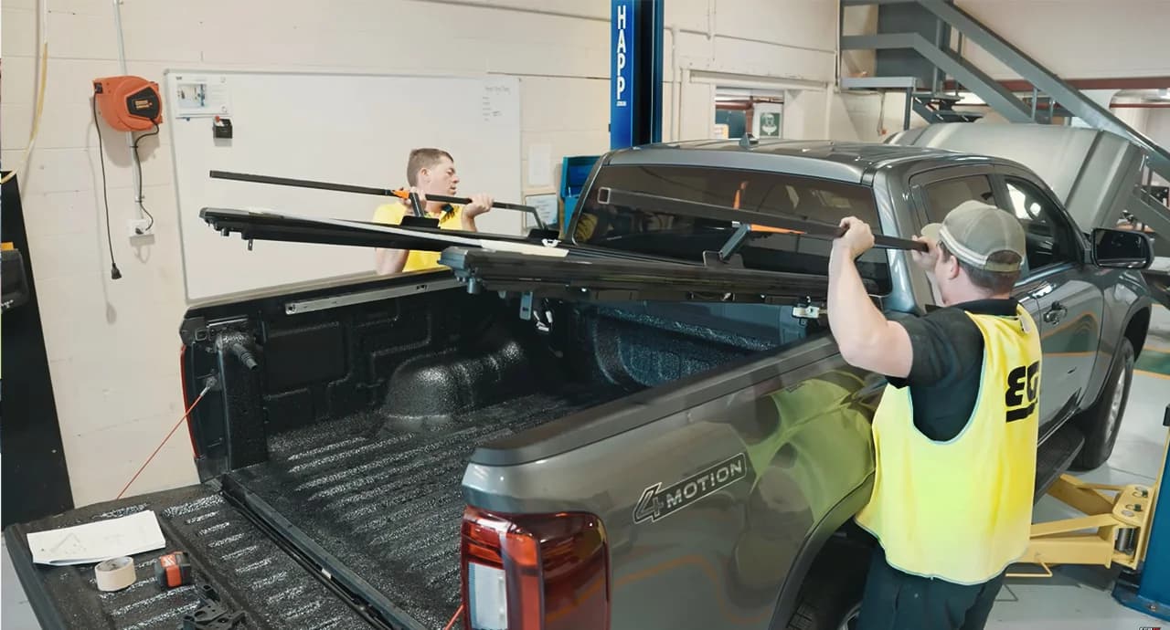 EGR technicians fitting a RollTrac tonneau cover