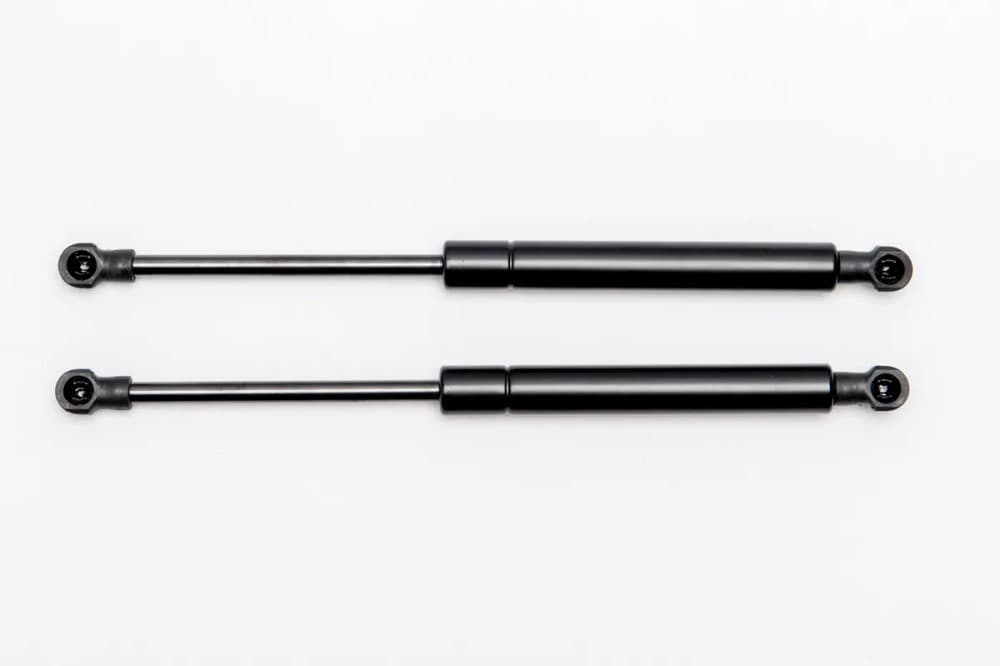 EGR Premium Canopy side lift window gas strut kit for Mitsubishi Triton MQ and MR pre-16/10/17, showing two black gas struts for smooth and supported window opening