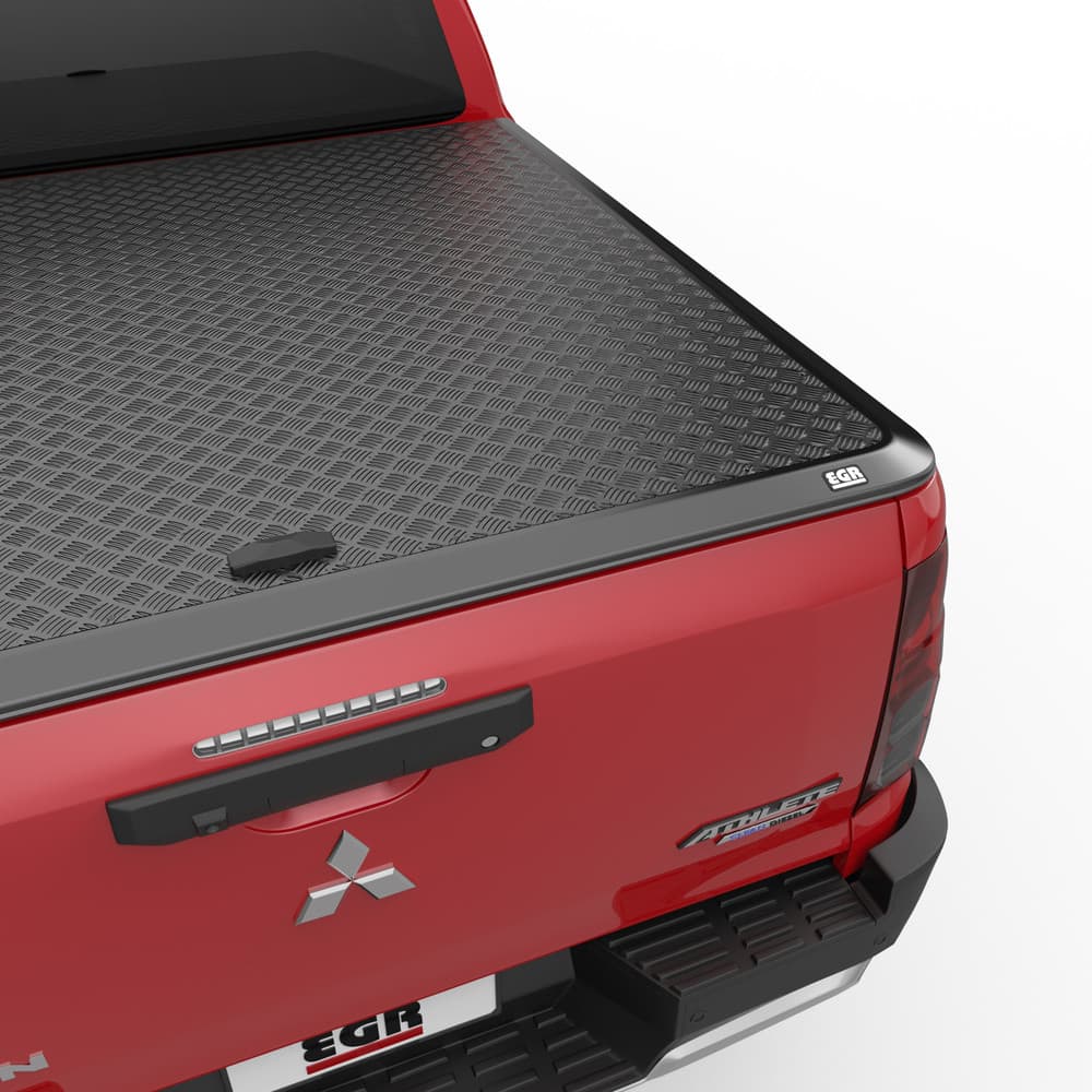 EGR Load Shield open on Mitsubishi Triton MV displaying durable aluminium checkerplate panel and secure tub coverage