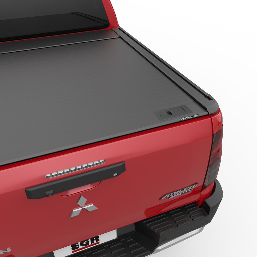 Close-up of EGR RollTrac Manual cover closed on Mitsubishi Triton MV, showing tight seal, flush fit, and secure manual locking system