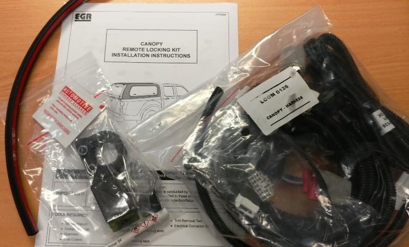 EGR Core Canopy remote locking kit for Isuzu D-Max 2020-onwards, including plug-and-play wiring harness, actuators, hardware, and installation instructions for integrating canopy rear door with factory central locking system