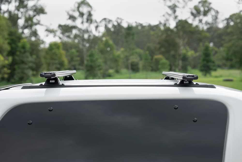 Detail view of EGR canopy crossbar mounting system showing secure clamp points and aluminium crossbar construction