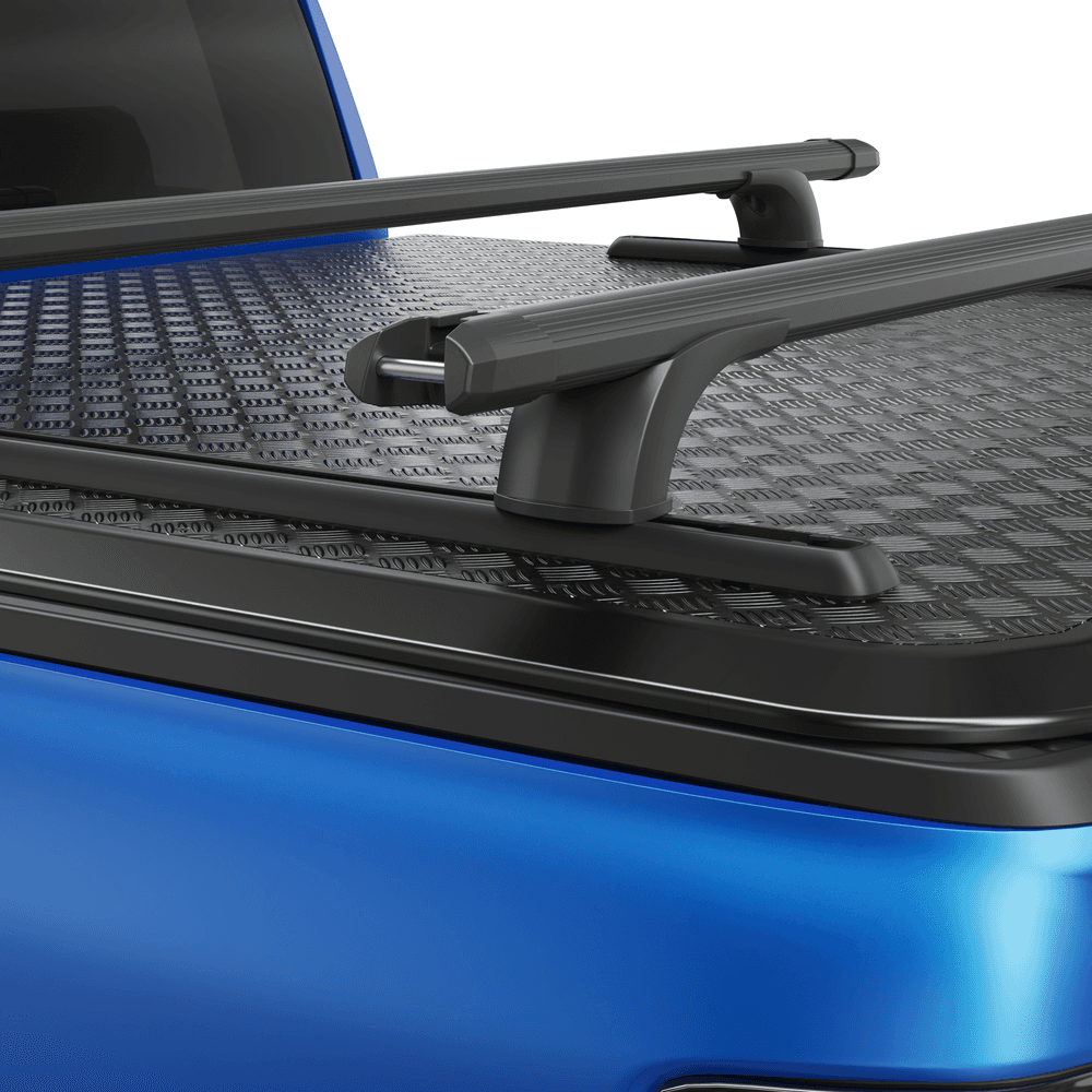 Detail view of black powder-coated RollTrac crossbar showing steel construction and mounting brackets