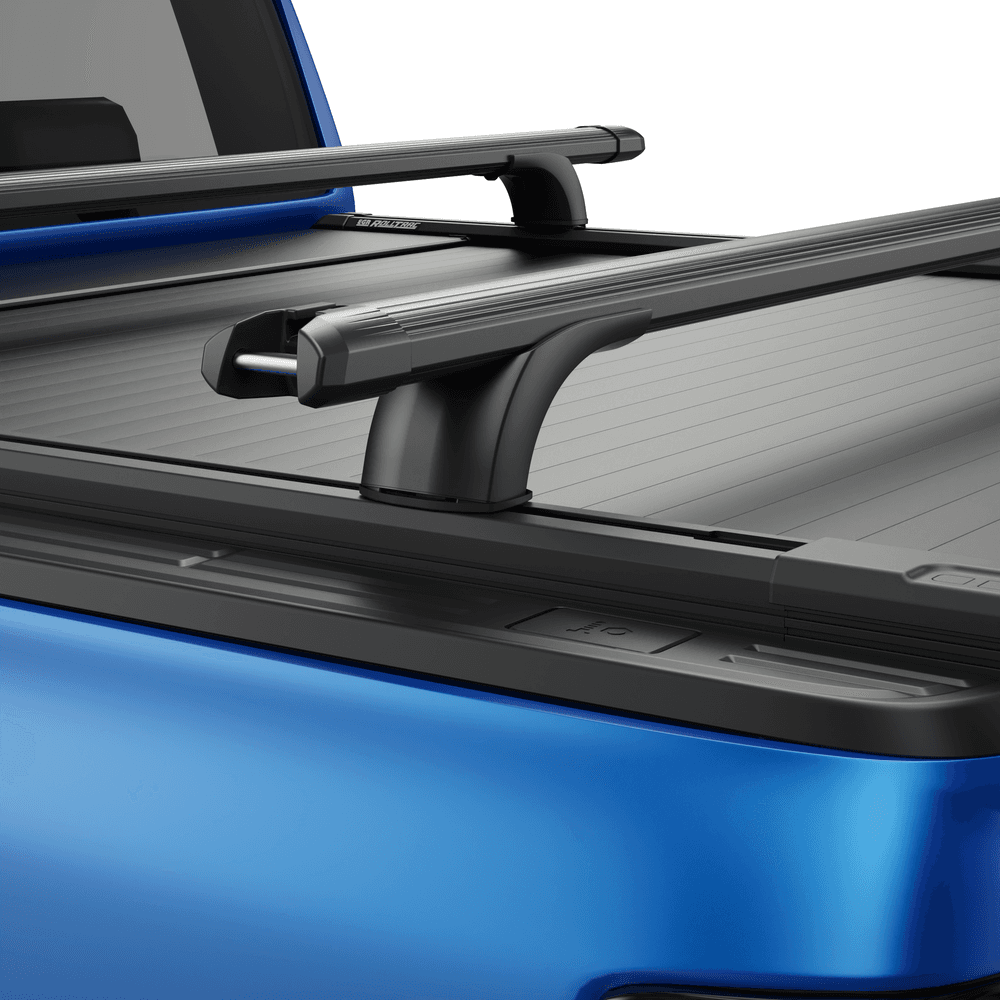 Detail view of black powder-coated RollTrac crossbar showing steel construction and mounting brackets