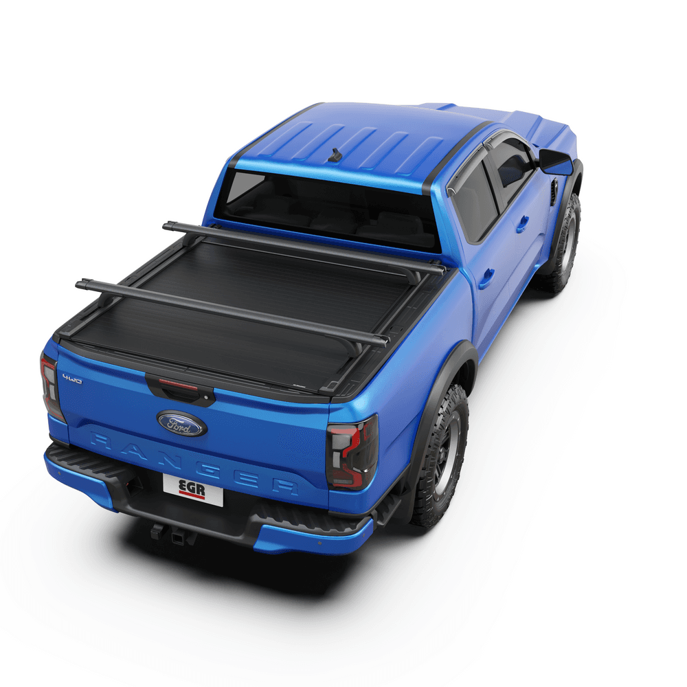 Top-down view of blue ute tub with EGR RollTrac Crossbars mounted securely over RollTrac cover