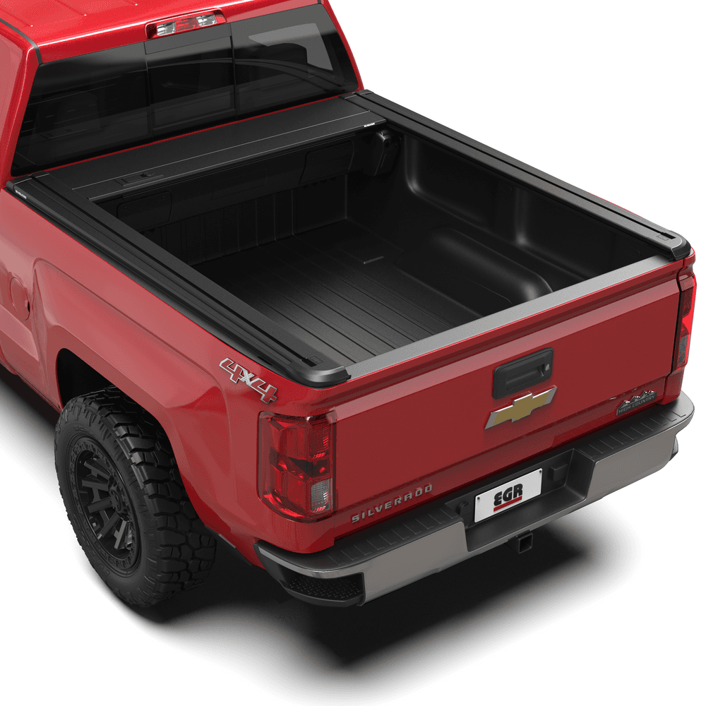 EGR RollTrac Manual tonneau cover partially open on Chevrolet Silverado 2500, showing secure sliding operation