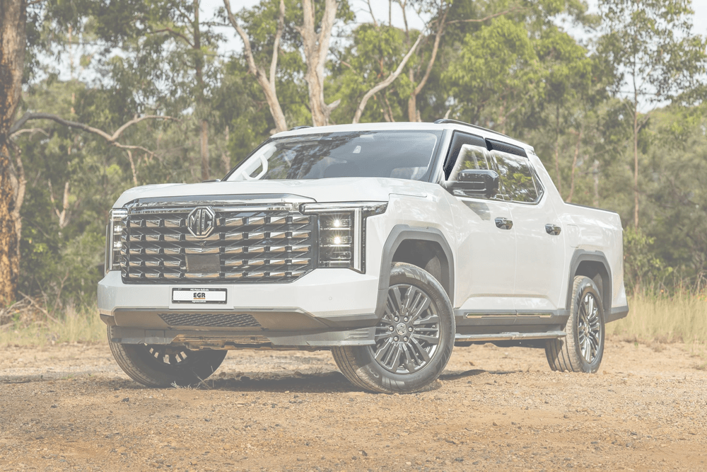 Front three-quarter view of white Ute with EGR matte black Slimline Weather Shields fitted