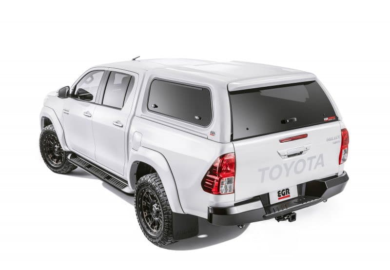 Rear side view of white Toyota Hilux with EGR Premium Canopy installed