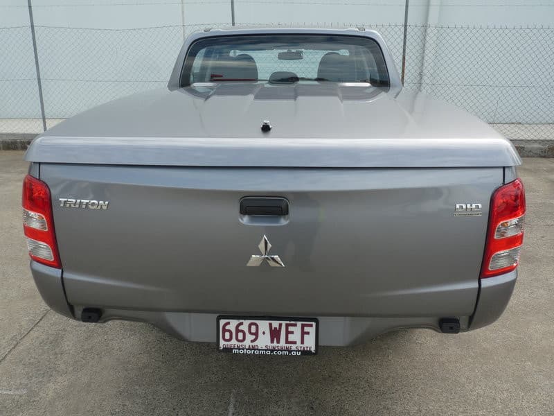 Rear angle of Mitsubishi Triton MQ/MR with EGR Hard Lid installed, showcasing secure push-button locking system
