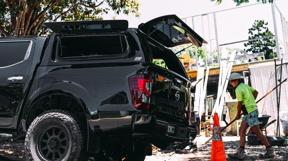 Nissan Navara MY21 with EGR GEN3 Canopy parked outdoors, side angle showing lift-up tinted windows and premium ABS construction