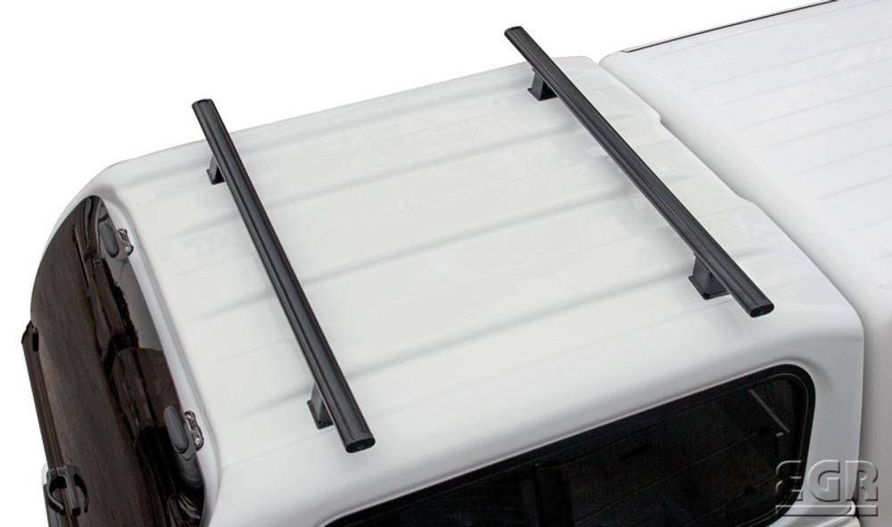 Close-up of EGR Premium Canopy Roof Rack Kit crossbars installed on Isuzu D-Max canopy, highlighting black powder-coated finish and secure mounting
