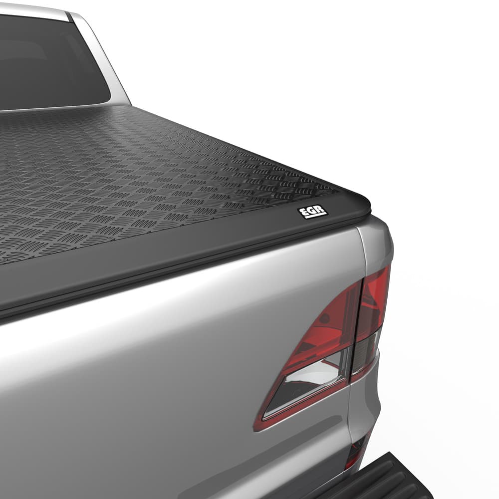 Close-up of EGR Load Shield corner latch on Mazda BT-50, highlighting secure locking and five-bar checker-plate surface