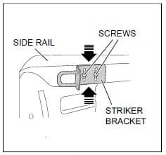 Diagram showing the striker bracket mounted to the side rail with two screws for the Nissan Navara D40 lock striker replacement kit