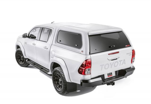 Rear side view of white Toyota Hilux with EGR Premium Canopy installed